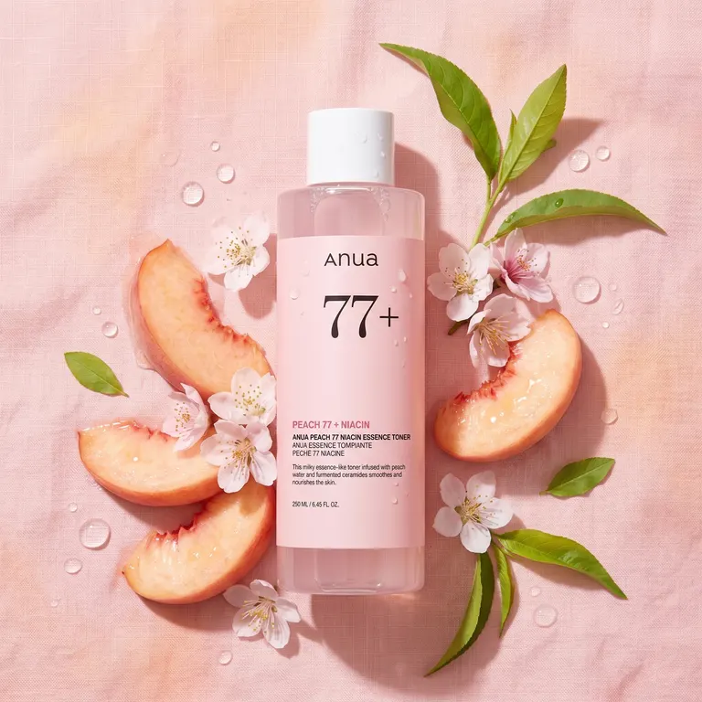 ANUA Peach 77 Toner with fresh peach slices and peach blossoms