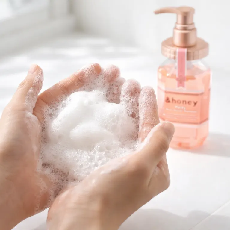 Hands lathering &Honey Melty Moist Repair Shampoo into rich foam