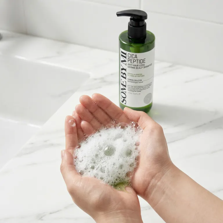 Hands lathering Some By Mi Cica Peptide Shampoo into rich foam