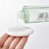 Beauty of Joseon Green Plum Toner clear liquid poured onto white cotton pad