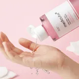 Applying Medicube PDRN Pink Cica Toner with cotton pad on hand