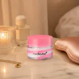 Medicube PDRN Lip Sleeping Mask on pink surface with salmon-colored silk